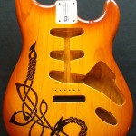 Celtic dragon design woodburned on guitar body