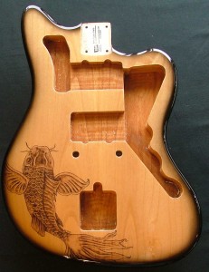 Koi fish design woodburned on guitar body with black burst finish