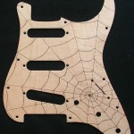 Spider web design woodburned on maple veneered aluminum pick guard - raw wood