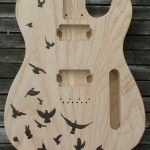 Design of birds woodburned on Ash Telecaster guitar body - raw wood